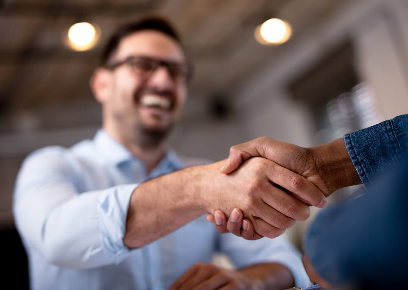 lender shaking hands with a business owner